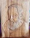 Volto di Padre Pio. Bassorilievo su legno di castagno.